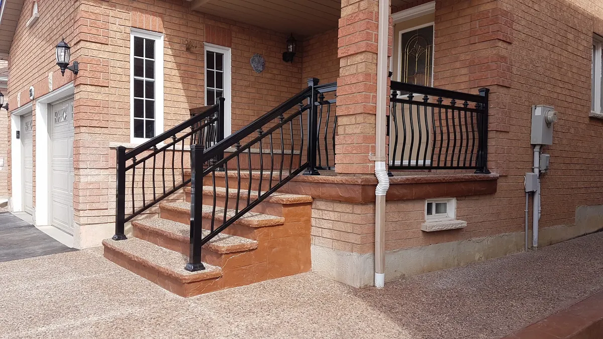 Black aluminum porch railing with square-section balusters and matching gate