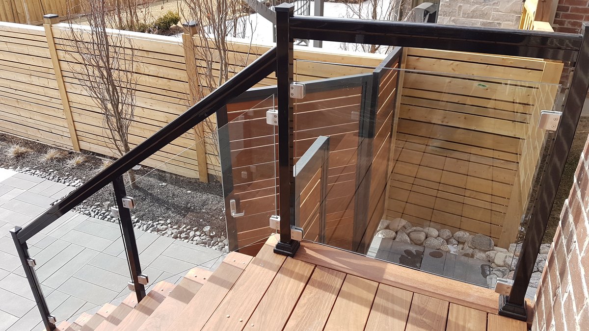 Frameless glass railing on stainless spigots
