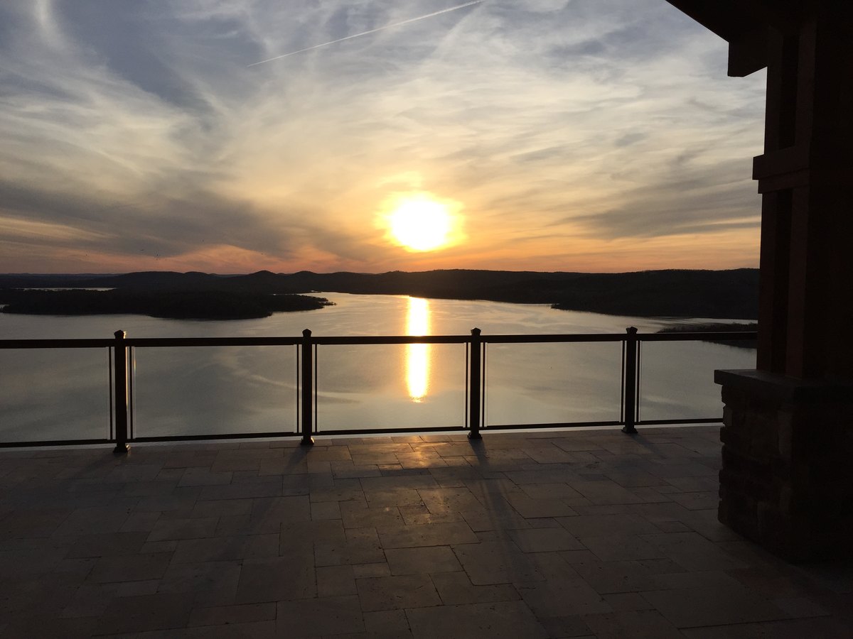 Glass railing on deck at sunset